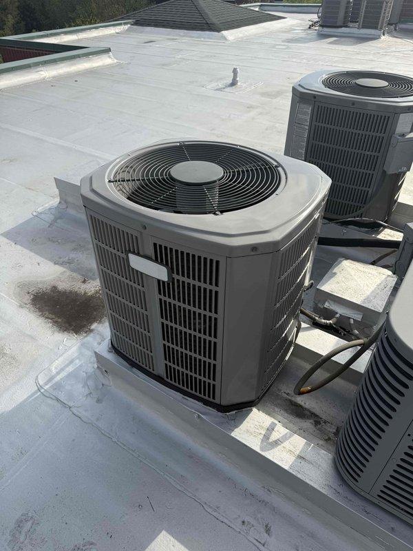 Responded to service call for reduced cooling capacity and intermittent hissing noise from rooftop HVAC unit. Performed diagnostic evaluation of commercial air conditioning system, taking temperature and pressure measurements at the air handler. Inspected rooftop condenser units and documented equipment conditions with photos for service records.