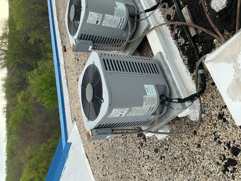 Performed routine maintenance tune-up on residential air conditioning system with air handler. Conducted comprehensive cleaning and check of both units, replaced air filter, and verified system operation with temperature readings at evaporator coil. Both outdoor condensing units inspected and confirmed operational with proper airflow through top-mounted fan grilles.
