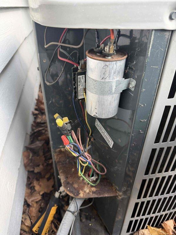 Completed spring preventative maintenance and clean and check on air conditioning system per service contract plan. Performed comprehensive inspection of outdoor condensing unit, including electrical components, capacitor testing with digital multimeter, and assessment of overall system condition. Noted rust accumulation on base plate and debris buildup in unit compartment; cleaned accessible areas and documented equipment condition with diagnostic readings for service records.