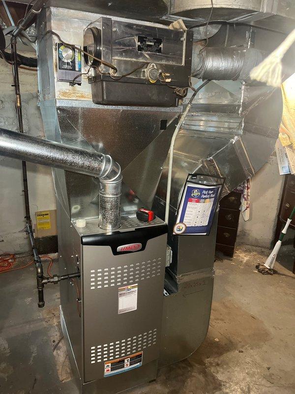 Completed HVAC system replacement in residential basement utility room following previous consultation and recommendation. Removed existing equipment and installed new Haller brand furnace unit with associated ductwork connections, including black flexible duct transitions and metallic plenum assembly. Installation includes proper PVC condensate drainage lines with appropriate fittings and elbows, system control wiring, and all necessary electrical connections. System commissioned and verified operational per manufacturer specifications.