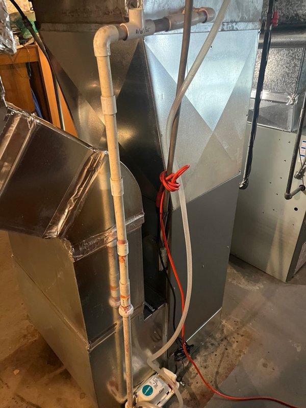 Completed HVAC system replacement in residential basement utility room following previous consultation and recommendation. Removed existing equipment and installed new Haller brand furnace unit with associated ductwork connections, including black flexible duct transitions and metallic plenum assembly. Installation includes proper PVC condensate drainage lines with appropriate fittings and elbows, system control wiring, and all necessary electrical connections. System commissioned and verified operational per manufacturer specifications.