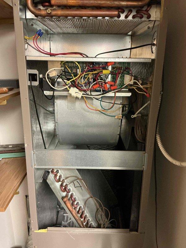 Completed comprehensive tune-up and inspection on single-system HVAC unit including air conditioning condenser and air handler. Performed clean and check procedures on all major components, inspected electrical connections and wiring, examined heat exchanger and blower assembly, and replaced air filter. All copper refrigerant lines, control board connections, and mechanical components were visually inspected and found to be operational, with minor oxidation noted on copper piping consistent with normal aging.