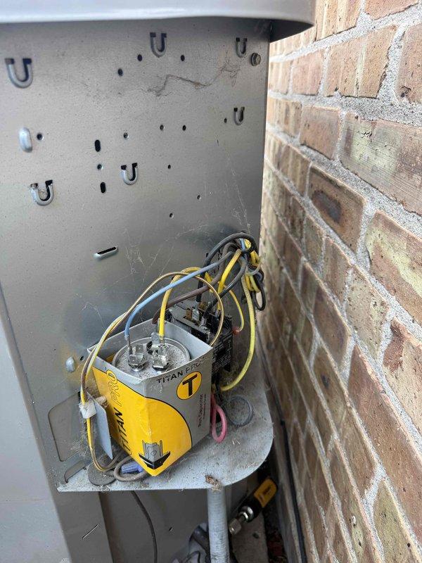 Completed spring preventative maintenance on air conditioning system per comfort plan agreement. Performed thorough clean and check procedures including inspection of control board, wiring connections, and outdoor disconnect components. Verified all electrical connections secure, tested system operation, and documented equipment condition with photos showing control board with proper wire management and outdoor disconnect housing with TITAN contactor in serviceable condition.