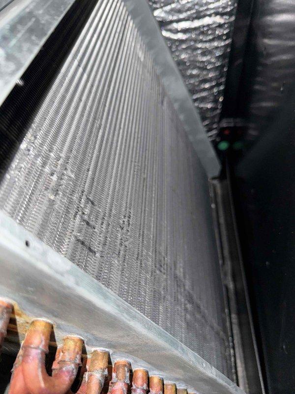 Completed comprehensive tune-up service on single HVAC system. Inspection revealed significant dust and debris accumulation on evaporator coil fins, which was documented and assessed for impact on system efficiency. Examined refrigerant lines showing normal oxidation patterns, verified all copper connections, and evaluated overall heat exchanger condition to ensure proper system operation.