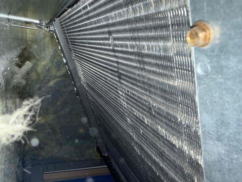 Completed comprehensive tune-up service on single HVAC system. Inspection revealed significant dust and debris accumulation on evaporator coil fins, which was documented and assessed for impact on system efficiency. Examined refrigerant lines showing normal oxidation patterns, verified all copper connections, and evaluated overall heat exchanger condition to ensure proper system operation.