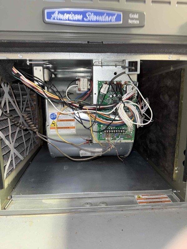 Completed comfort plan clean and check maintenance on American Standard Gold Series air conditioning system. Performed comprehensive system inspection including electrical measurements with clamp meter, verifying amperage draw at 13.6 amps. Changed media filter per service contract plan requirements. Inspected control boards, wiring connections, and internal components with access panel removed. All system components operating within normal parameters upon completion of maintenance service.