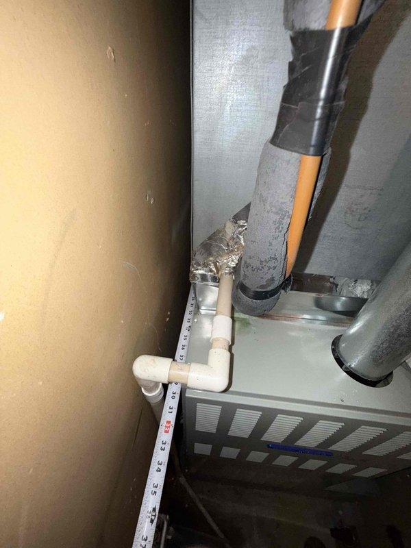 Responded to service call for circuit breaker tripping issue affecting furnace operation. Conducted thorough inspection of aging HVAC system including light green air handler unit, associated ductwork, refrigerant lines, and condensate drain piping. Documented equipment dimensions and captured detailed photographs of installation for replacement assessment purposes. Due to age and condition of existing equipment, provided measurements and visual documentation to support replacement quote preparation for property management review.