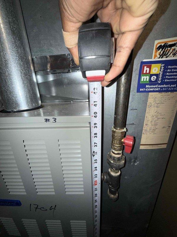 Responded to service call for circuit breaker tripping issue affecting furnace operation. Conducted thorough inspection of aging HVAC system including light green air handler unit, associated ductwork, refrigerant lines, and condensate drain piping. Documented equipment dimensions and captured detailed photographs of installation for replacement assessment purposes. Due to age and condition of existing equipment, provided measurements and visual documentation to support replacement quote preparation for property management review.