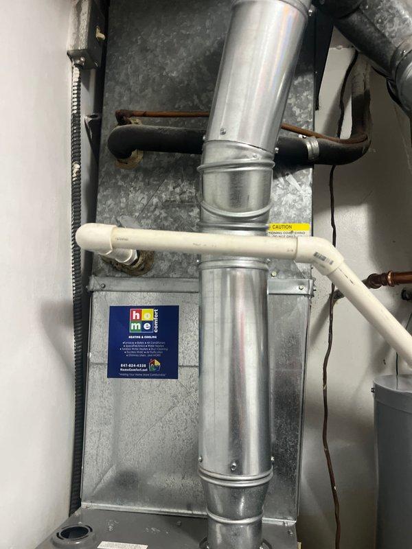 Completed HVAC estimate for air conditioning system replacement. Assessed existing outdoor condenser unit showing significant rust deterioration on top panel and fan guard area, along with indoor air handler and ductwork system in basement utility area. Also evaluated 2010 water heater that has exceeded typical lifespan and likely contains sediment buildup affecting efficiency, providing replacement options including traditional tank and tankless configurations for customer consideration.