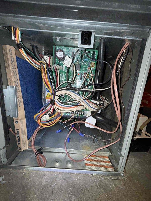 Completed comprehensive Comfort Plan maintenance on single air conditioning system. Performed thorough inspection of furnace cabinet and control components, including examination of green control board, electrical connections, and wire harnesses. Inspected blower wheel assembly for proper operation and cleanliness, noting dust accumulation on blades. Verified air filter condition and all safety labels present. All electrical connections secure, control board functioning properly, and system operational at time of departure.