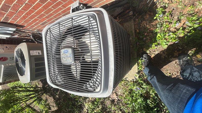 Performed seasonal air conditioning start-up service and diagnosed condenser noise issue on residential outdoor unit. Inspected condenser unit, electrical disconnect, and associated components mounted on exterior wall. Discussed service contract renewal options covering multiple HVAC systems including air conditioners, mini-split, and furnaces, with maintenance scheduling recommended for upcoming month.