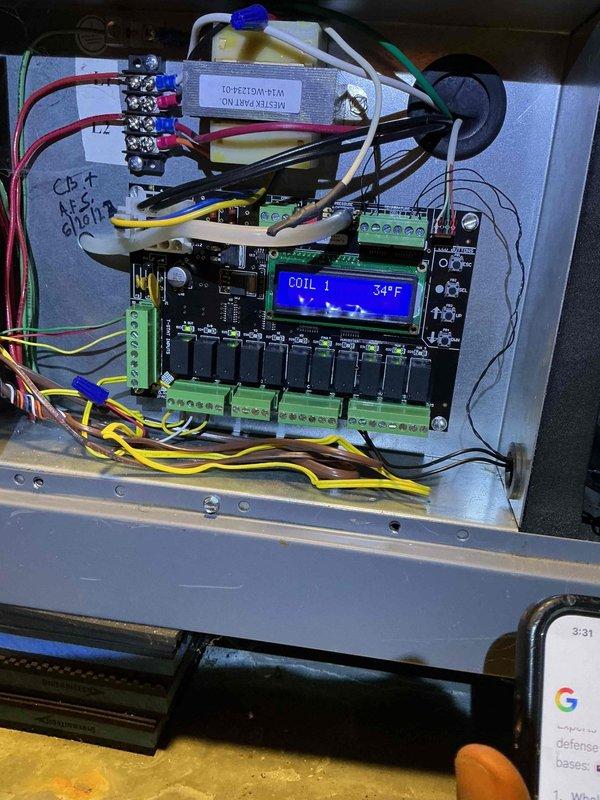 Replaced defective circuit board in Spacepak HVAC system controller under warranty. Upon arrival, system displayed "HEATING COIL1 NOT FOUND" error message on LCD screen, indicating communication failure between main controller and heating coil. Removed failed circuit board from control panel, disconnected all wire terminations from green terminal blocks, and installed new replacement board. Reconnected all colored wire leads to appropriate terminals, verified proper seating of connections, and powered up system. Confirmed LCD display showed normal operating temperature reading of 34°F for Coil 1, indicating successful restoration of system communication and functionality. Retained defective circuit board for return to office for warranty processing and manufacturer credit.