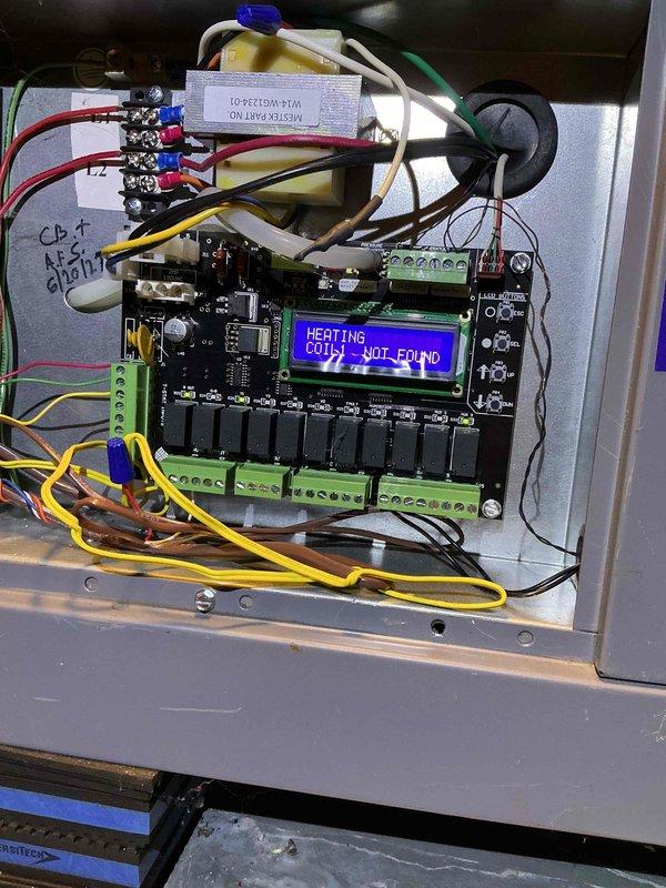 Replaced defective circuit board in Spacepak HVAC system controller under warranty. Upon arrival, system displayed "HEATING COIL1 NOT FOUND" error message on LCD screen, indicating communication failure between main controller and heating coil. Removed failed circuit board from control panel, disconnected all wire terminations from green terminal blocks, and installed new replacement board. Reconnected all colored wire leads to appropriate terminals, verified proper seating of connections, and powered up system. Confirmed LCD display showed normal operating temperature reading of 34°F for Coil 1, indicating successful restoration of system communication and functionality. Retained defective circuit board for return to office for warranty processing and manufacturer credit.