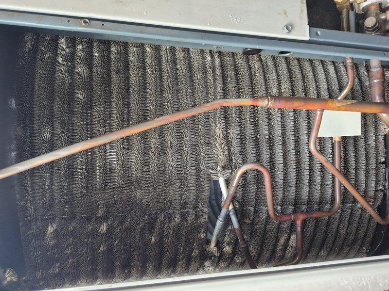 Completed annual air conditioning clean and check maintenance per Comfort Plan agreement. Performed comprehensive system inspection of furnace and evaporator coil assembly, documenting existing dust and debris accumulation on coil fins. Inspected all electrical connections, control board, blower motor assembly, refrigerant lines, and condensate management components to ensure proper system operation and identify any maintenance concerns.