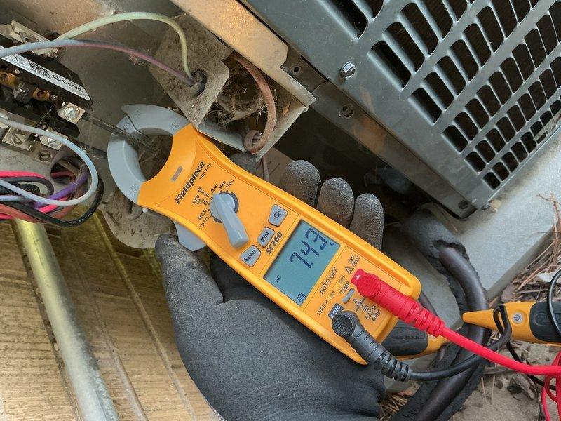 Completed comprehensive air conditioning tune-up on Goodman condensing unit system. Performed electrical diagnostics with multimeter confirming proper voltage at 71.5V, inspected all refrigerant line connections and insulation integrity, verified fan assembly operation, and conducted complete system assessment of both indoor and outdoor components. All equipment found operating within normal parameters with no immediate concerns noted.