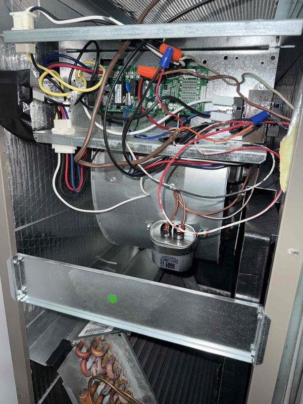 Responded to no cooling complaint with indoor temperature not reaching below 75 degrees. Performed diagnostic inspection of residential air handler unit, accessing internal components including control board, capacitor, and refrigeration connections. Documented system configuration and current operating conditions with detailed photography of electrical components, wiring harnesses, and evaporator coil assembly for further analysis and service recommendations.