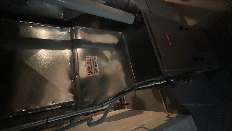 Conducted on-site evaluation of existing 30-year-old air conditioning system for replacement estimate. Inspected outdoor condensing unit located behind lattice screening at building exterior and assessed indoor air handler components including ductwork connections and system infrastructure. Documented current equipment configuration, mounting locations, and existing installation parameters to provide comprehensive replacement recommendations and sizing requirements for new AC system installation.