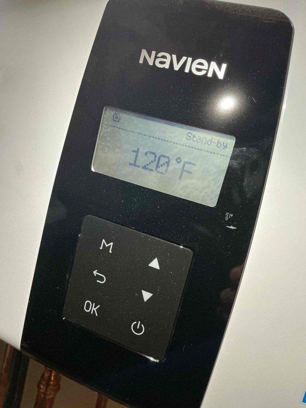 Responded to complaint of extended hot water delivery time on Navien tankless water heater. Inspected unit control panel and verified standby mode operation at 120°F setpoint. Evaluated internal mechanical components including circulation pump assembly, flow sensor, and electrical connections to ensure proper system function and optimal heating response time.