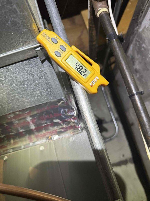 Responded to no cooling complaint on residential air conditioning system installed in 2023. Upon arrival, confirmed ice formation on evaporator coil and low refrigerant charge. Performed electrical diagnostics using clamp meter to verify compressor amperage and capacitor function. Measured suction line temperature at 48.1°F, indicating inadequate refrigerant levels. System requires refrigerant leak detection and repair under warranty coverage before recharging to manufacturer specifications.