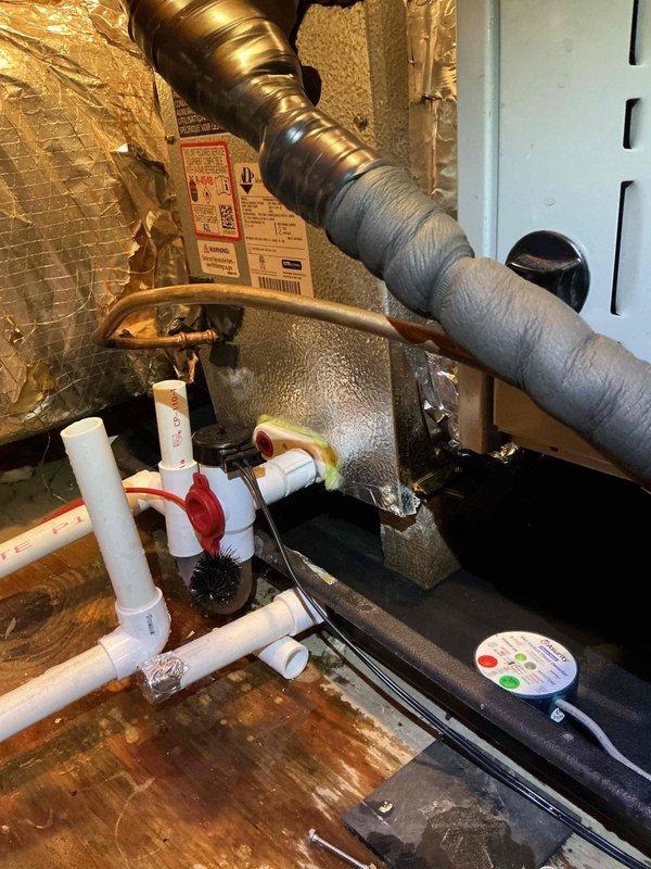 Completed callback service on 9-month-old AC system located in attic space. Inspected condensate drain system with PVC piping and verified proper drainage flow through drain pan equipped with monitoring gauge. Replaced air filter with new Glasfloss unit and confirmed all ductwork connections secure. System operational and cooling properly upon departure.