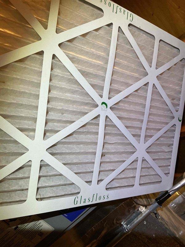 Completed callback service on 9-month-old AC system located in attic space. Inspected condensate drain system with PVC piping and verified proper drainage flow through drain pan equipped with monitoring gauge. Replaced air filter with new Glasfloss unit and confirmed all ductwork connections secure. System operational and cooling properly upon departure.