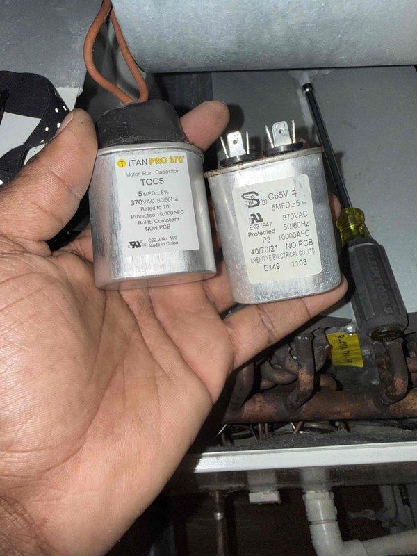 Replaced two failed capacitors in HVAC unit that were previously diagnosed during prior service visit. Removed old capacitors and installed new TITAN PRO 370 VAC replacement capacitors, ensuring proper electrical connections and secure mounting of all components.