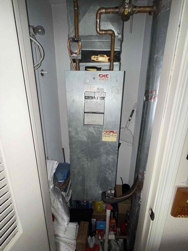 Completed comprehensive tune-up maintenance on residential HVAC system located in utility closet. Performed standard preventive maintenance procedures including inspection of unit components, verification of airflow through ventilation grilles, examination of copper refrigerant lines and connections for proper condition, and assessment of overall system operation. Unit found to be in functional condition with no immediate repairs required; documented equipment status with photographs for service records.