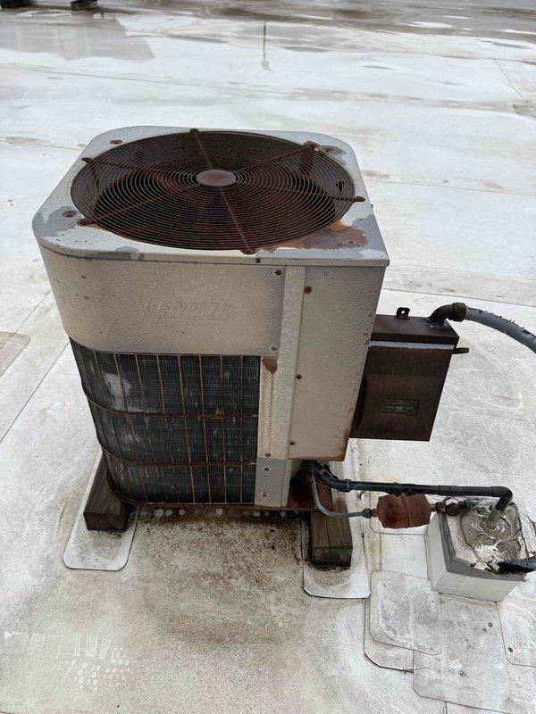 Completed Comfort Plan clean and check maintenance on two air conditioning systems. Performed comprehensive inspection of older Lennox rooftop condenser unit, noting visible weathering, rust formation, and oxidation on cabinet surfaces and fasteners; verified electrical disconnect box connections and assessed overall unit condition. Documented significant ductwork deterioration in attic space, including severely damaged insulation on refrigerant line with complete breakdown of insulation material at termination point, and observed rust staining and age-related wear on metal duct components. Inspected flexible aluminum ductwork and noted general system aging concerns. All operational data recorded for both systems as part of routine maintenance protocol.