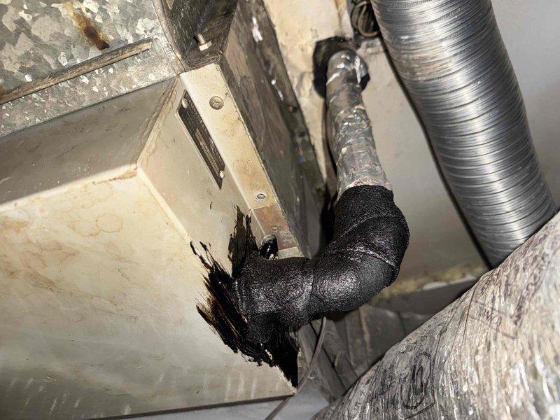 Completed Comfort Plan clean and check maintenance on two air conditioning systems. Performed comprehensive inspection of older Lennox rooftop condenser unit, noting visible weathering, rust formation, and oxidation on cabinet surfaces and fasteners; verified electrical disconnect box connections and assessed overall unit condition. Documented significant ductwork deterioration in attic space, including severely damaged insulation on refrigerant line with complete breakdown of insulation material at termination point, and observed rust staining and age-related wear on metal duct components. Inspected flexible aluminum ductwork and noted general system aging concerns. All operational data recorded for both systems as part of routine maintenance protocol.