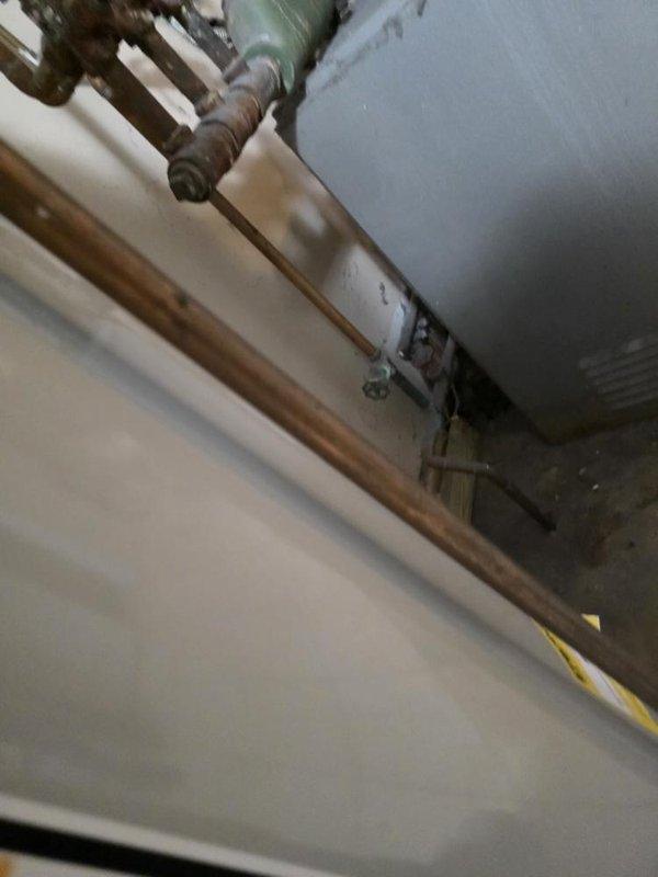 Conducted site assessment of existing boiler system in three-unit residential building. Evaluated 70-year-old original equipment located in basement, documented current installation including copper piping configuration, circulation pump, and water heater connections. Photographed mechanical room layout and existing equipment for replacement estimate preparation.