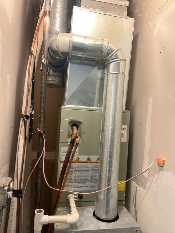 Conducted comprehensive AC replacement estimate for residential system that ceased operation during previous cooling season. Evaluated existing Ameristar furnace/air handler installation with associated refrigerant lines, ductwork, and condensate drainage system in basement utility area. Customer elected to defer repairs at end of last season and is now pursuing complete system replacement options. Documented current equipment configuration including copper refrigerant piping, PVC condensate lines with emergency float switch, electrical conduit, and silver galvanized supply ductwork for accurate replacement specifications.