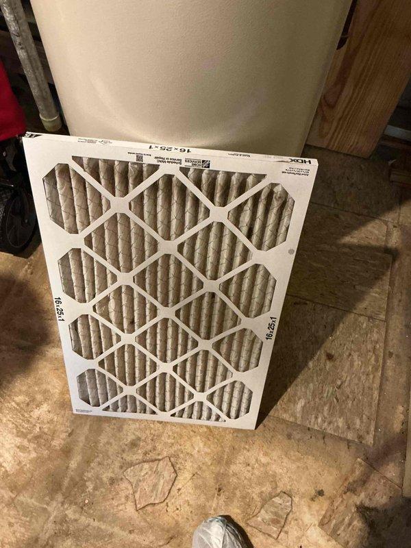 Responded to no cooling complaint on residential WeatherMaker 9200 system with ecobee3 lite thermostat showing 8-degree temperature differential. Performed diagnostic evaluation of furnace and air handler unit in basement mechanical room, inspected ductwork connections and plenum assembly. Documented heavily soiled 16x25x1 air filter with significant particulate buildup restricting airflow, which was identified as primary cause of inadequate cooling performance and reduced system efficiency.