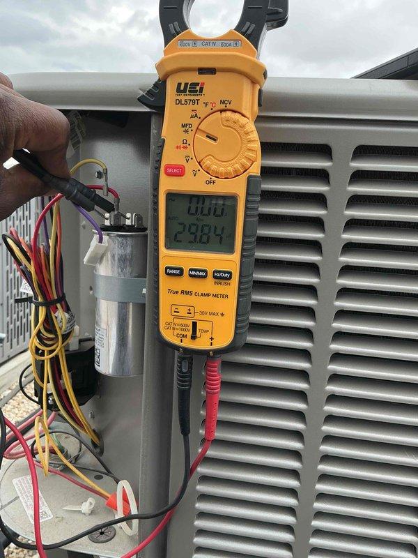 Performed clean and check service on single air conditioning system per building specifications. Conducted electrical diagnostics using clamp meter, measuring voltage at 238.4V and verifying amperage draw on outdoor condensing unit. Inspected capacitor, wiring connections, and terminal blocks; all electrical components found secure and functioning properly. Contacted customer regarding optional filter replacement with no response received. System operating within normal parameters upon completion of tune-up service.