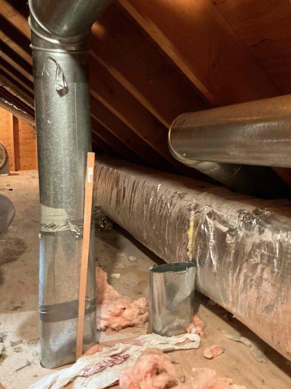 Completed HVAC install callback to address drainage backup issue in attic-mounted system. Eliminated auxiliary drain pan line that was previously tied into the primary coil drain line before entering gutter, which had been causing water backup. Modified drainage configuration to rely solely on wet switch and EZ trap switch for future water damage protection. System tested and verified operational with updated safety switches functioning properly.
