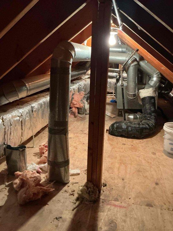 Completed HVAC install callback to address drainage backup issue in attic-mounted system. Eliminated auxiliary drain pan line that was previously tied into the primary coil drain line before entering gutter, which had been causing water backup. Modified drainage configuration to rely solely on wet switch and EZ trap switch for future water damage protection. System tested and verified operational with updated safety switches functioning properly.
