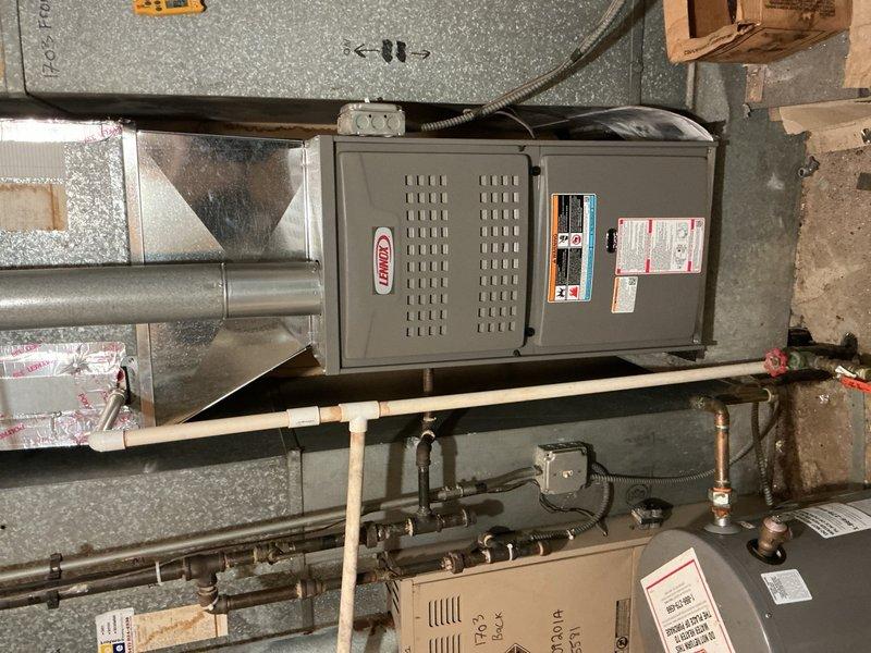 Completed furnace replacement for unit 1703, disconnecting existing forced air furnace and installing new Lennox furnace unit in basement utility area. Connected new furnace to existing supply and return air ductwork with necessary sheet metal transitions, attached to existing gas line, electrical circuit, and exhaust venting. Mounted furnace on wooden platform, secured all ductwork connections with proper insulation, and routed refrigerant lines and condensate piping as required. Performed complete system start-up, tested and adjusted all equipment for proper operation, verified gas pressure and combustion efficiency, and completed comprehensive safety inspection. System is fully operational with 5-year parts warranty and 1-year extended labor warranty in effect. Old furnace left on site per customer request.