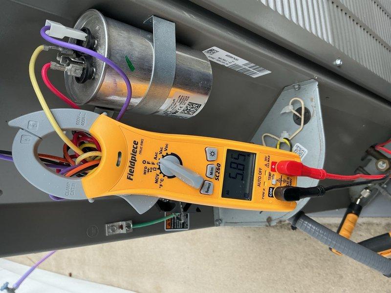 Performed comprehensive Comfort Plan clean and check maintenance on single HVAC system. Conducted electrical diagnostics using clamp meter to measure amperage draw and verify proper system operation. Tested dual run capacitor performance and confirmed all electrical connections were secure with appropriate wire terminations. Measured voltage and current readings on capacitor terminals to ensure component functionality within manufacturer specifications. Inspected control panel components, wiring integrity, and electrical connections throughout system. All tested components operating within normal parameters with no deficiencies noted. System confirmed to be functioning properly upon completion of maintenance visit.