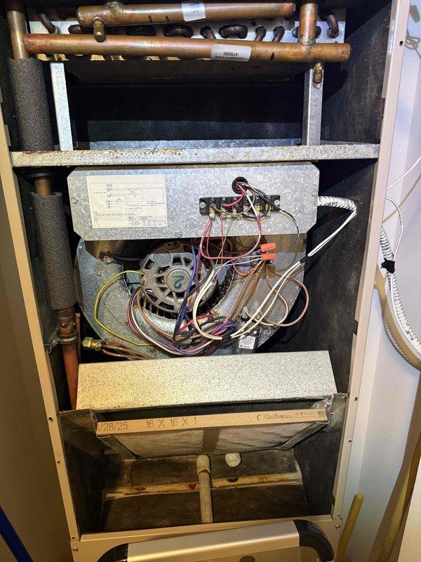Completed comprehensive tune-up and clean-and-check service on a single HVAC system per building specifications. Performed thorough inspection of air handler unit including evaporator coil, blower motor assembly, gas valve controls, and electrical connections; documented system components and filter size specifications (16x15x1). Inspected outdoor condensing unit which displayed significant rust and corrosion on top panel and fan assembly area, noting weathering conditions; verified all electrical connections and disconnect boxes were secure across multiple rooftop units in the installation area.