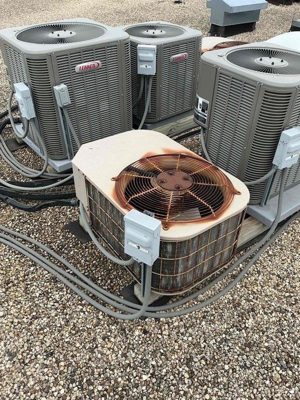 Completed comprehensive tune-up and clean-and-check service on a single HVAC system per building specifications. Performed thorough inspection of air handler unit including evaporator coil, blower motor assembly, gas valve controls, and electrical connections; documented system components and filter size specifications (16x15x1). Inspected outdoor condensing unit which displayed significant rust and corrosion on top panel and fan assembly area, noting weathering conditions; verified all electrical connections and disconnect boxes were secure across multiple rooftop units in the installation area.
