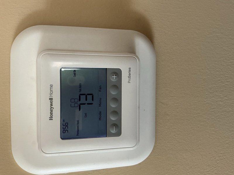 Completed comprehensive tune-up on single-system HVAC unit. Performed standard maintenance procedures including inspection of blower motor assembly, verification of electrical components and capacitor functionality, and diagnostic testing with multimeter to ensure proper voltage and amperage readings. Verified Honeywell thermostat operation showing system maintaining 77°F setpoint. Unit operating within normal parameters with no filter present at time of service.