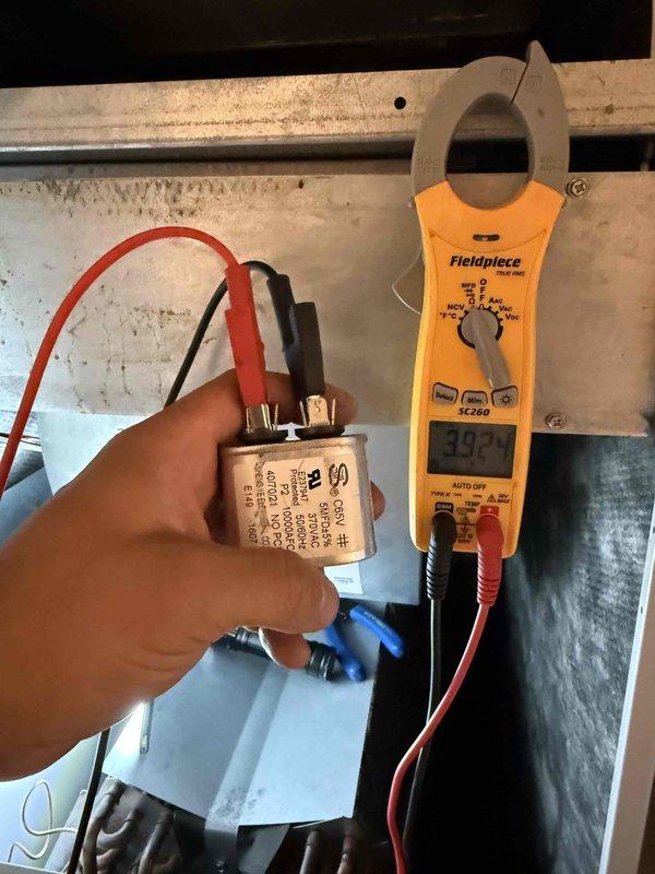 Performed comprehensive tune-up service on single residential HVAC system. Tested and verified run capacitor functionality using digital clamp meter, confirming proper capacitance reading of 30.3 microfarads within manufacturer specifications. Completed full system inspection of rooftop-mounted air conditioning unit, verifying operational status of condenser fan, coil condition, and electrical connections. Provided air filter per customer request and collected applicable service fee.