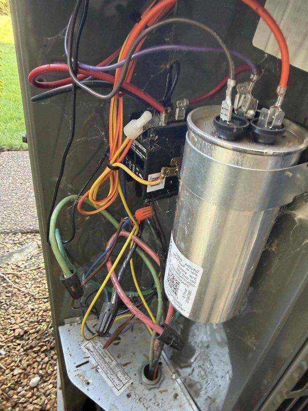 Completed air conditioning clean and check per service comfort plan. Performed comprehensive inspection of air handler components including blower motor assembly, electrical connections, and capacitor. Verified proper operation of all system components, confirmed secure wire connections at motor and contactor, and documented equipment condition through photographic records.