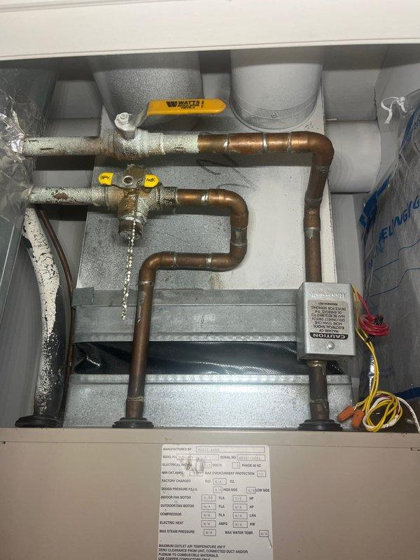 Completed HVAC estimate for 1.5 ton condo air conditioning system replacement. Inspected existing air handler and condensing unit in closet installation, noting corroded copper refrigerant lines, active water leak at valve connection, and mineral deposits indicating long-term moisture issues. Documented equipment condition with photos showing deteriorated piping, condensation on suction line, and overall system wear. Customer declined air filter replacement at this time, requesting filter size information and replacement schedule be provided during future installation visit.