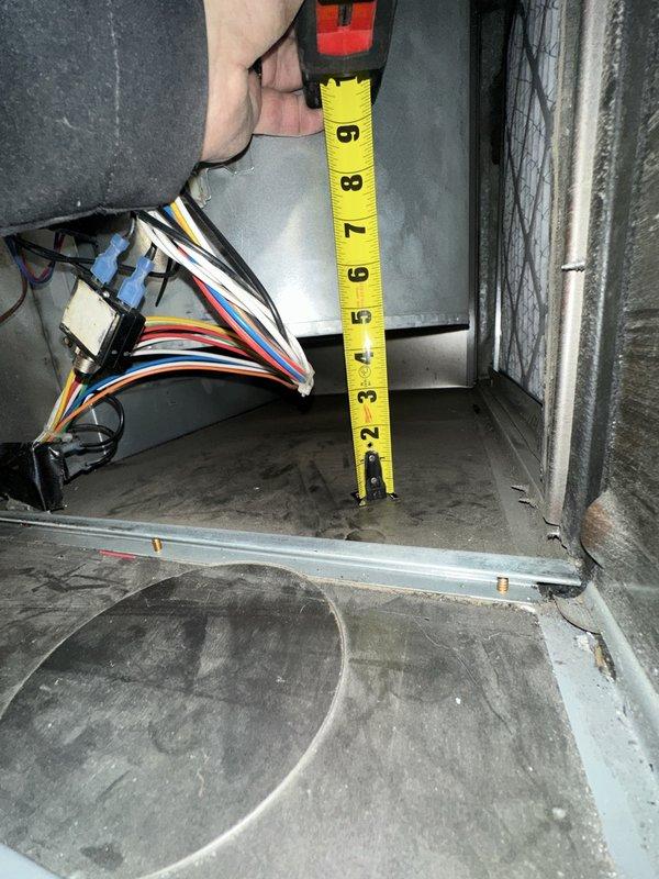 Responded to service call for loud furnace operation in commercial HVAC system. Upon inspection, investigated evaporator coil assembly and air handler unit to identify source of excessive noise. Performed diagnostic assessment of coil mounting, internal clearances, and component positioning within the air handler cabinet. Measured critical spacing dimensions to verify proper installation tolerances and identify potential contact points causing operational noise. Examined wire harness routing and securing to ensure electrical components were not contributing to vibration or noise issues. Assessed condition of evaporator coil fins, mounting brackets, and drain pan supports for proper alignment and secure attachment. Troubleshot mechanical components and verified adequate clearance between coil assembly and cabinet walls to prevent rattling or vibration transfer during system operation. Identified and resolved clearance issue causing noise complaint, ensuring all components properly secur