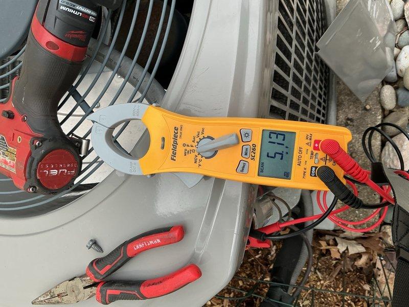 Completed spring clean and check on outdoor air conditioning unit per comfort plan agreement. Performed comprehensive electrical diagnostics using clamp meter, recording amperage draw of 4.5 amps and verified system voltages at 5.5V and 5.26V on capacitor circuits. Inspected internal electrical components including contactors, capacitors, and wiring connections; removed access panel to access electrical compartment for thorough examination. Cleaned condenser unit, checked fan assembly operation, and confirmed all components functioning within normal parameters. System operating properly with no deficiencies noted at time of service.