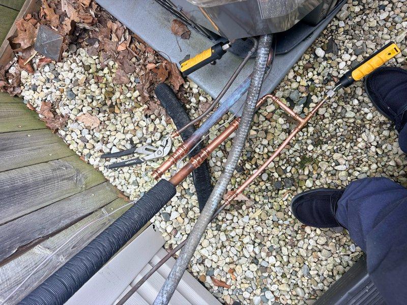 Performed ISO test on 5-year-old Unico air conditioning system under warranty coverage. Inspected outdoor HVAC unit and refrigerant line connections, including copper lines with insulation and associated condensate drainage components. Follow-up visit scheduled to complete additional warranty testing procedures on the system.