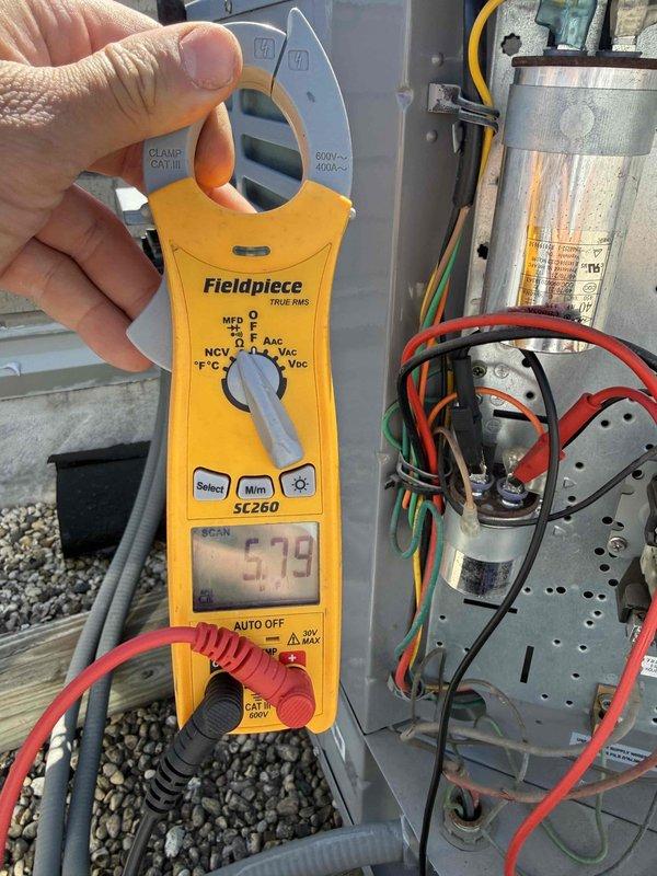 Completed comprehensive air conditioning maintenance and tune-up service per building special requirements. Performed electrical diagnostics on outdoor condensing unit using clamp meter, recording amperage readings of 5.79 amps and verifying proper operation of capacitor and electrical connections. Measured supply air temperature at indoor air handler registering 54.1°F, confirming adequate cooling performance and proper refrigerant charge. Installed customer-requested 16x20x1 air filter to maintain optimal airflow and system efficiency.
