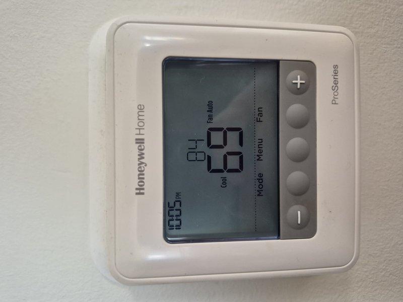 Completed air conditioning and air handler maintenance per building special requirements. Performed comprehensive system tune-up on single HVAC unit, including inspection of thermostat operation, electrical connections, and blower motor assembly. Installed 16x20x1 air filter as requested by customer and documented system conditions with photos showing Honeywell ProSeries thermostat and internal mechanical components in proper working order.