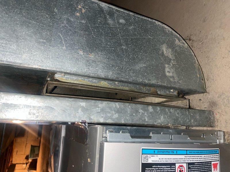 Completed Comfort Plan preventive maintenance on single-system air conditioning unit. Performed comprehensive clean and check inspection including visual assessment of air handler and ductwork, which revealed significant dust and debris accumulation on return air ductwork and cabinet surfaces. Verified system operational status and took temperature measurements using calibrated digital multimeter to assess performance parameters. Unit confirmed operational at time of service with customer reporting no current issues. Documented equipment condition through photographic records showing dust buildup on galvanized ductwork and HVAC cabinet requiring attention during routine maintenance cycle.