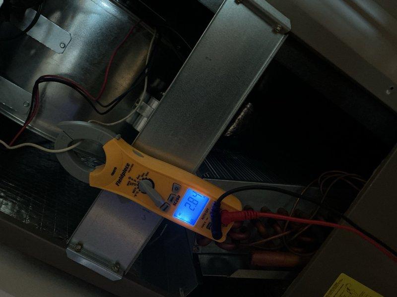 Completed spring tune-up on 2.5-ton AC system including evaporator coil inspection and electrical diagnostics using digital multimeter to verify proper voltage and amperage at air handler unit. Customer declined filter replacement at time of service. System operating within normal parameters with all components functioning properly.